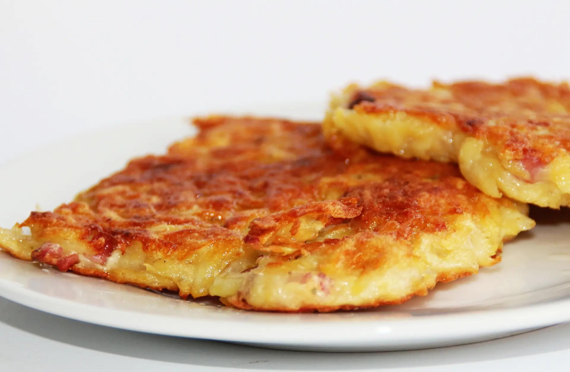 An image of hashbrowns with some bacon bits mixed in.
