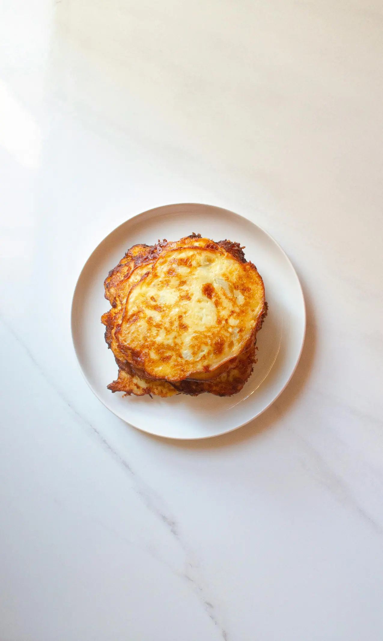 A top shot of potato pancakes on a plate.